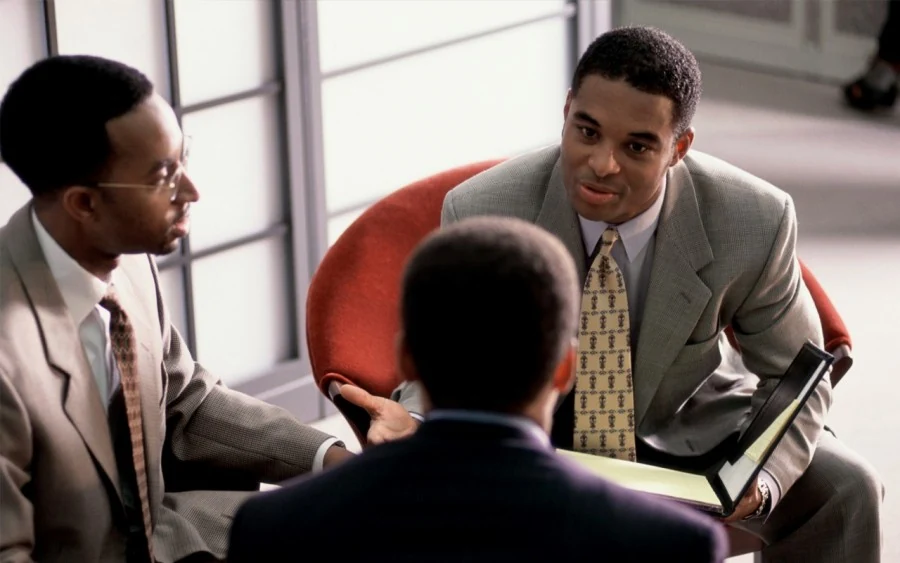 Black professionals discussing ideas in a meeting